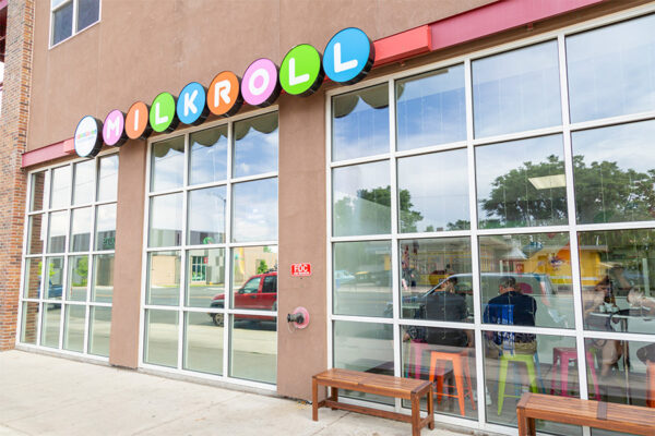 Milkroll ice cream shop with glass walls and colorful chairs.