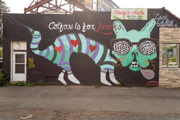 Street art mural with cat wearing glasses.