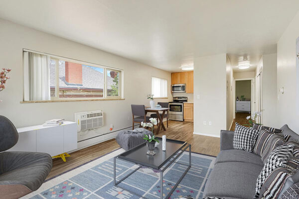 Living area with plush furniture, dining table, and updated kitchen.