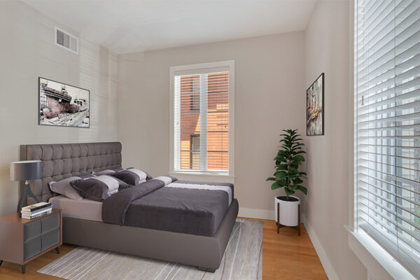 Bedroom with wood floor, rug, platform bed, potted plant, and large windows.