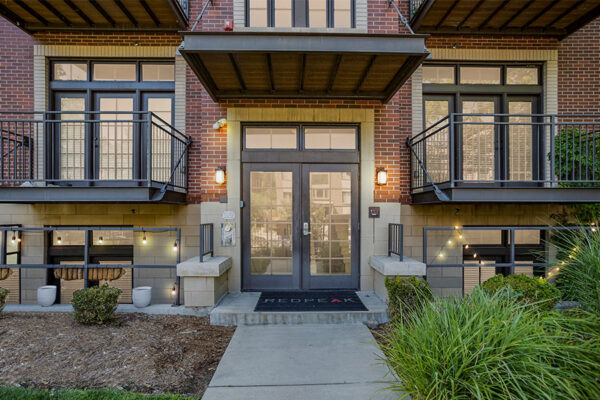 1145 Ogden apartment building entrance with contemporary architecture and brick construction.
