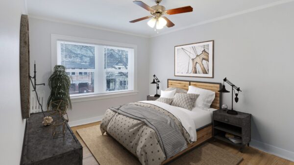 bedroom with bed in the center, ceiling fan, large dresser and window.
