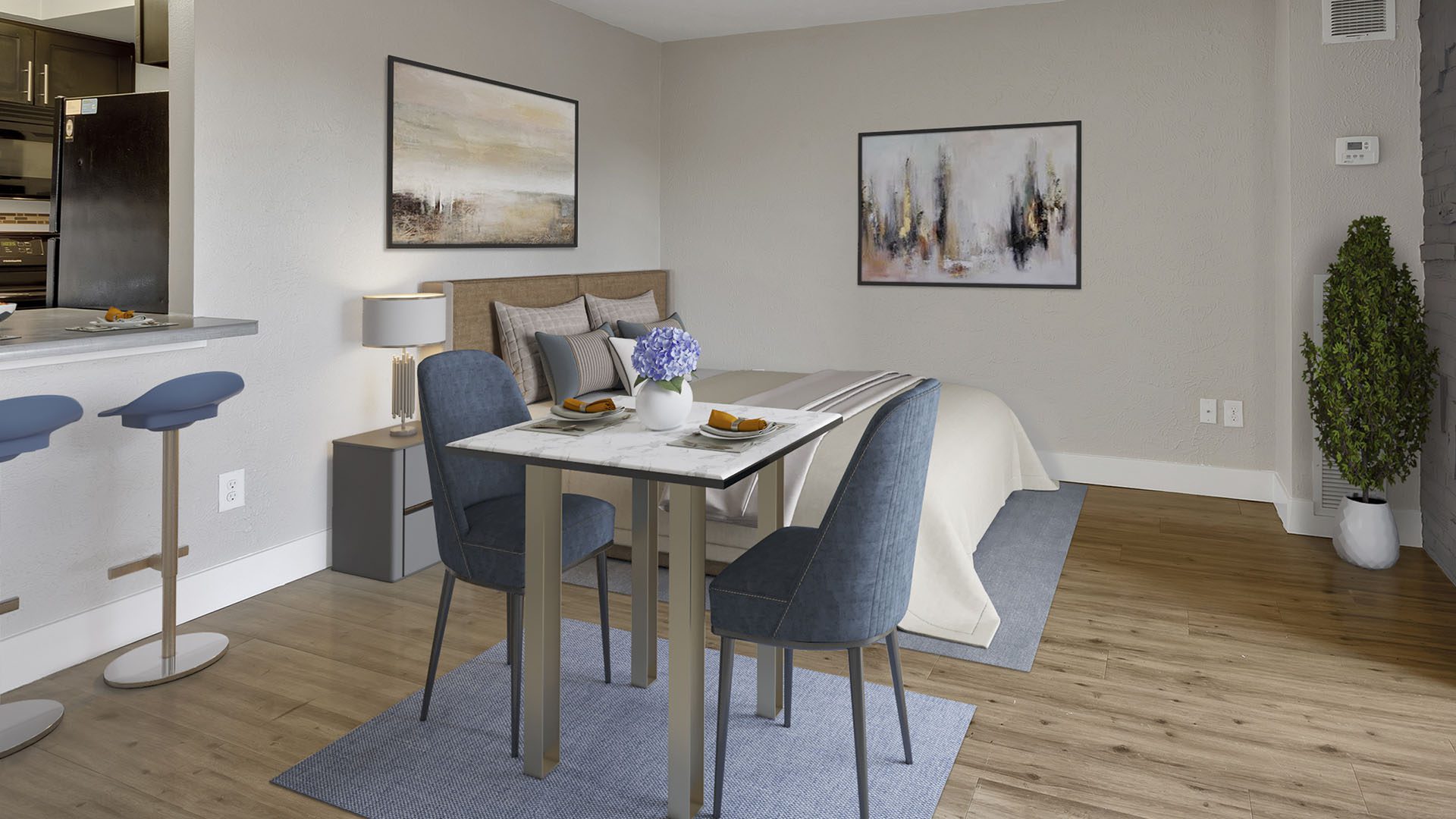 Rendering of studio living space with dining table, plush bed, breakfast bar, and framed artwork.