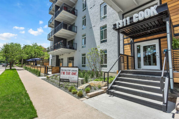 1311 Cook entrance with slatted wood patio and monument sign.