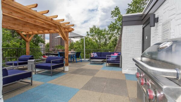 Outdoor seating area with a cabana and a grill.