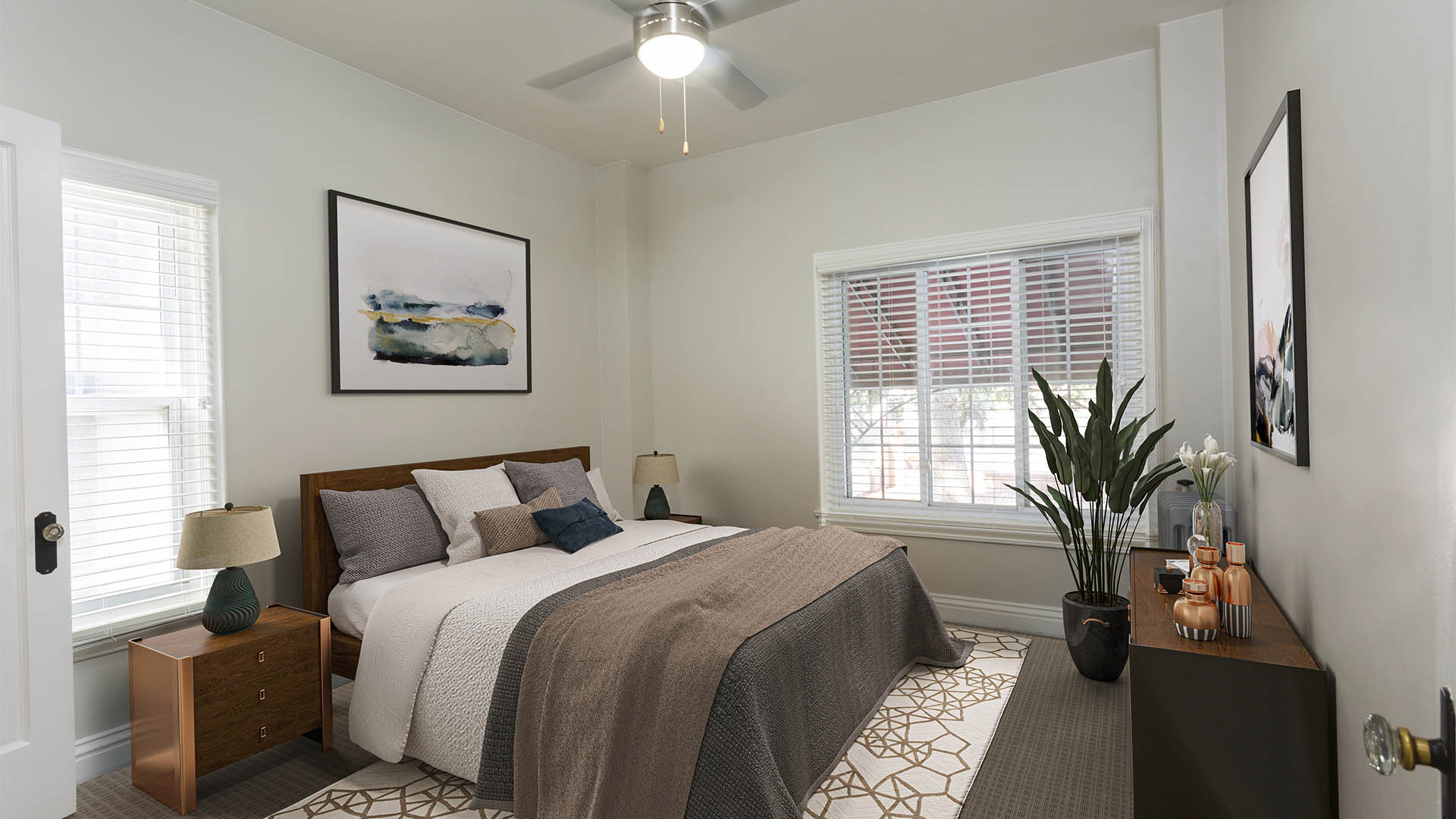 Bedroom with plush rug, large bed, and bedside tables with lamps.