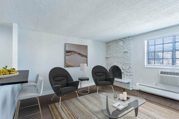 Apartment living room with modern furniture, wall art, and fireplace.