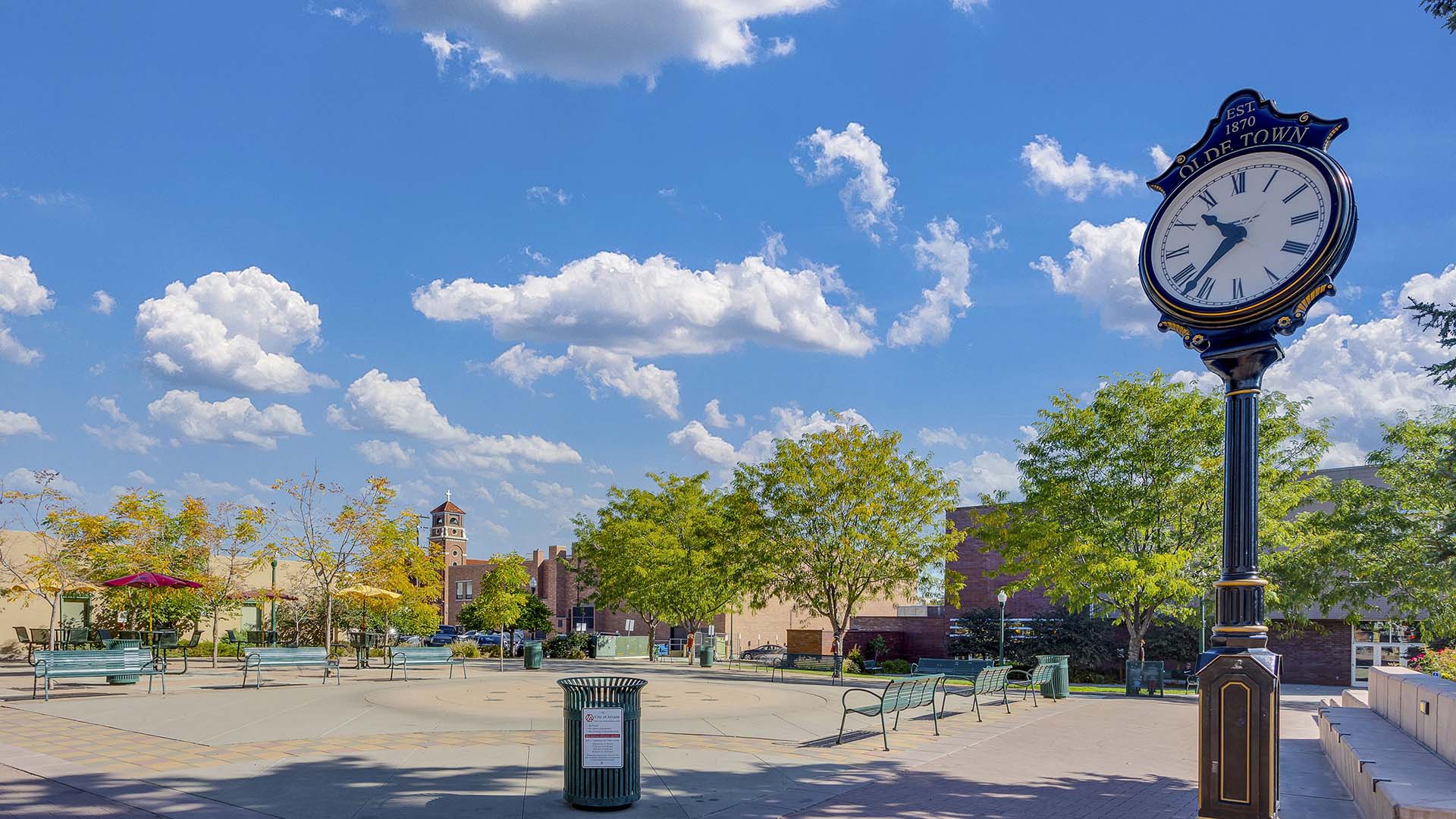 Olde Town Arvada with public square, benches, trees, and clock.