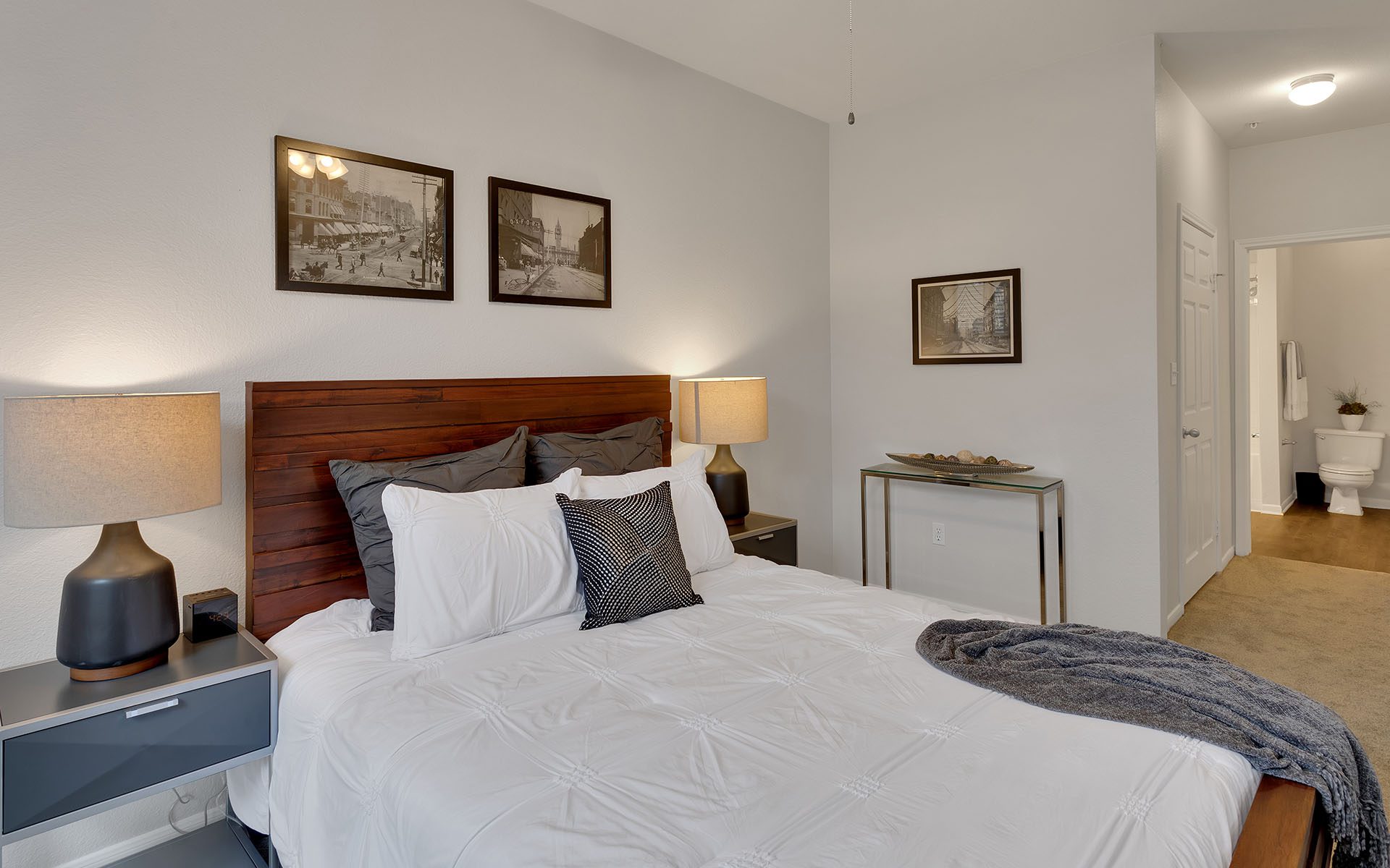 Bedroom with queen size bed and dresser.