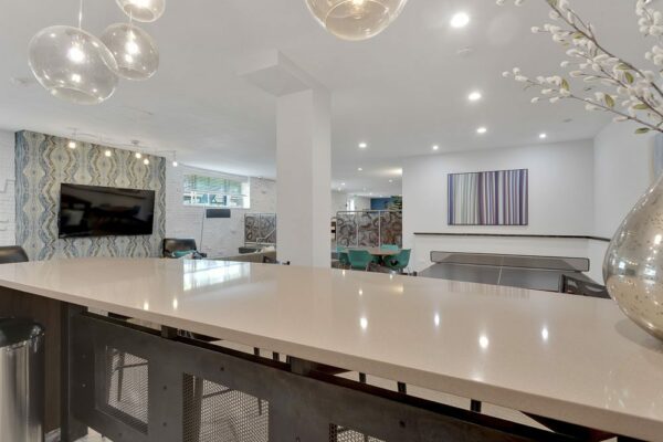 Demo kitchen bar top overlooking table tennis and dining tables.
