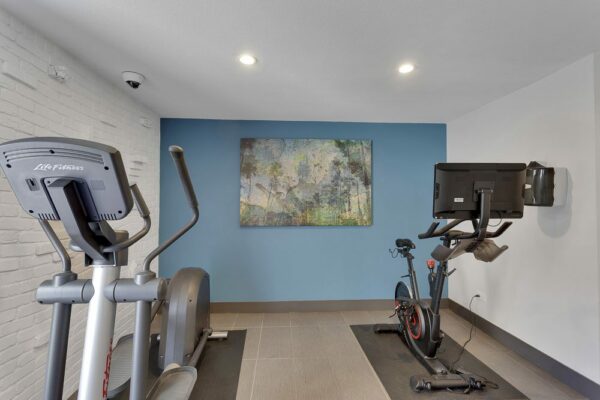 Fitness center with elliptical and spin bike.