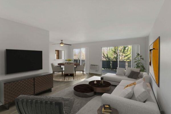 Living room with plush section, modern furniture, and large balcony doors.