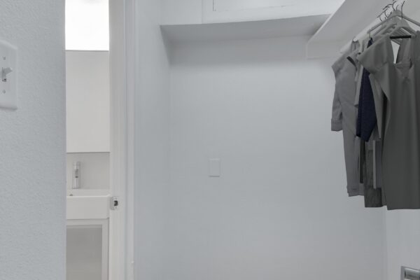 closet leading to a bathroom of a studio apartment