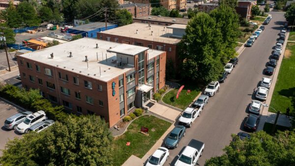 Aerial view of 870 Cherry building with brick construction, grassy lawn, and street parking.