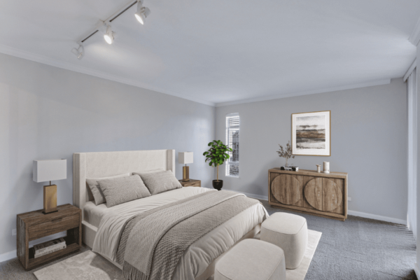 bedroom with large bed, dresser, and door to balcony