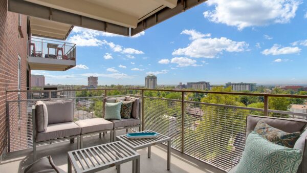 Balcony with outdoor furniture overlooking Denver.