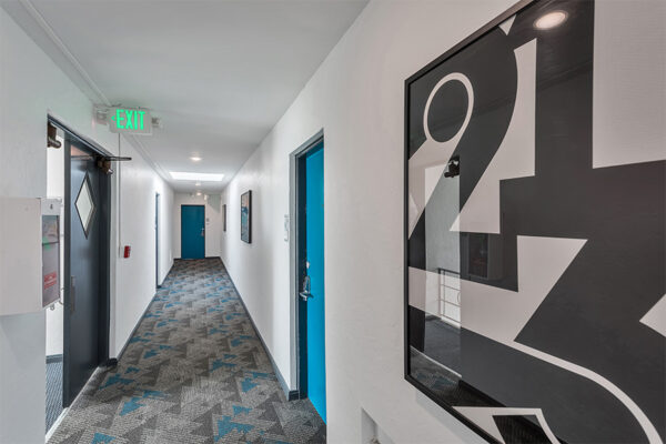 611 East 11th hallway with geometric carpet and number wall decor.