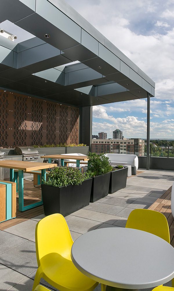 Rooftop lounge with bbq grills and mountain views.