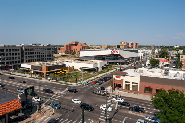 Aerial view of Postino restaurant, AMC theater, and Trader Joe's nearby.