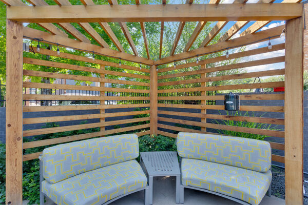 Detail of wood pergola with plush outdoor sectional.