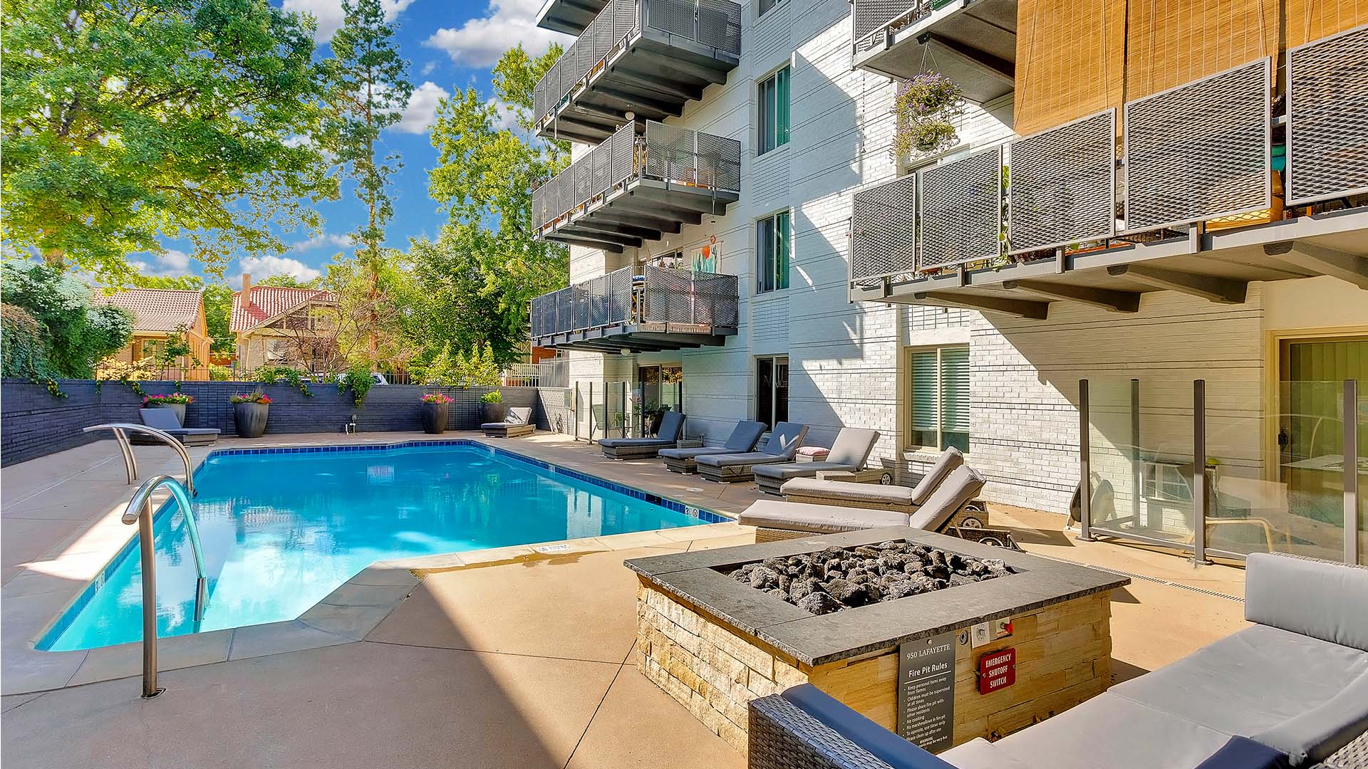 950 Lafayette pool area with a fireplace and chairs.