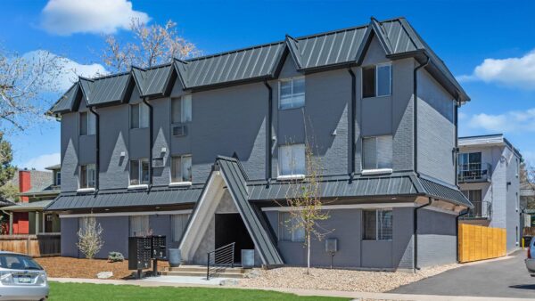 960 S Logan apartments with gray brick construction and ample parking.