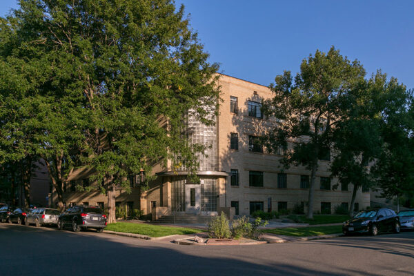 970 Penn building with blonde brick art deco construction and tall trees.