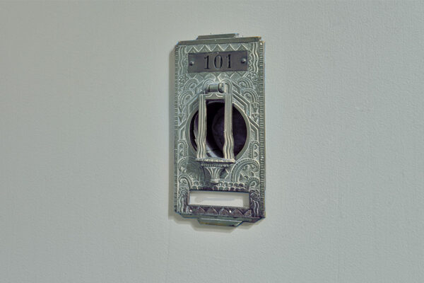 Classic art deco door knocker for unit 101.