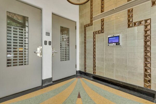 970 Penn apartments lobby with decorative wall tiles and art deco floor.