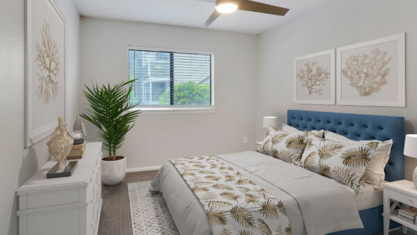 Hadley bedroom with king size bed, plant and dresser.