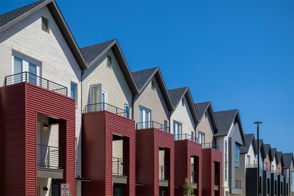 Dayton Station townhomes with red metal siding and balconies.