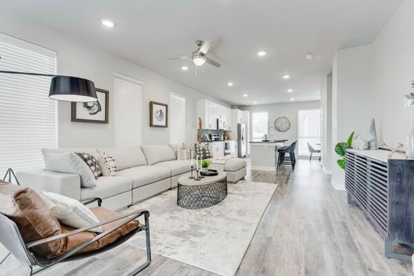 Living area with comfortable modern living room and bright open kitchen.