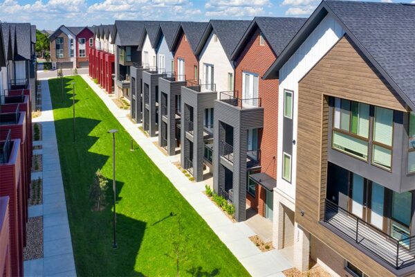 Aerial view of Dayton Station townhomes with balconies overlooking lush lawn.