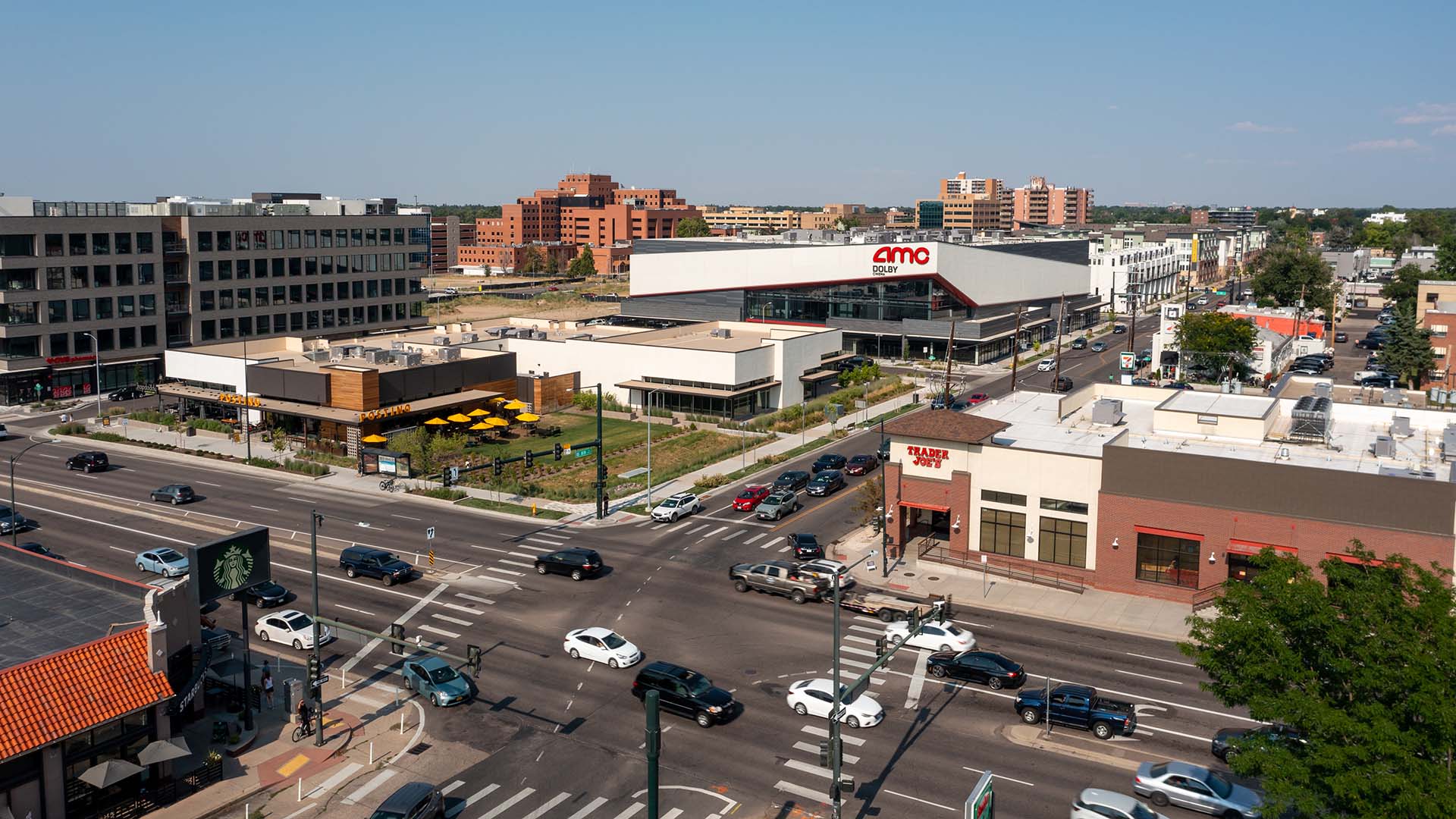 Aerial view of intersection with Trader Joes, AMC theater, and Postino restaurant.