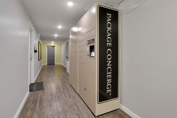 Liv On Steele apartment hallway with package locker labeled 