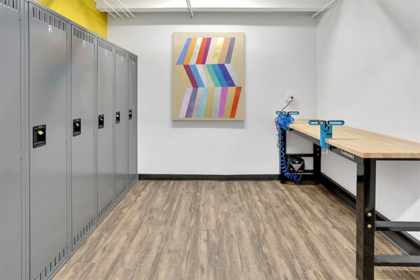 Storage room with work bench, storage lockers, and graphic wall painting.
