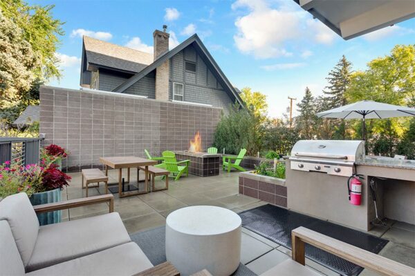 Patio with plush outdoor furniture, built in BBQ grill, and fire pit.