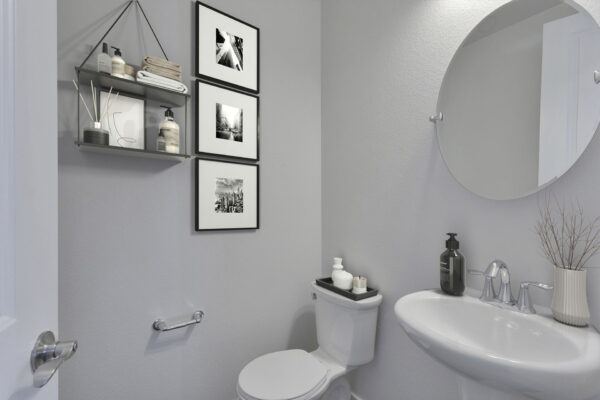 Rendering of a powder room with white walls.