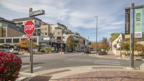 Corner of Clayton street in Cherry Creek lined with shops and apartments.