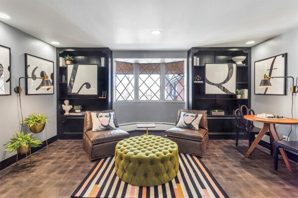 Lounge with end grain wood floor, built in shelves, modern furniture, and eclectic decor.