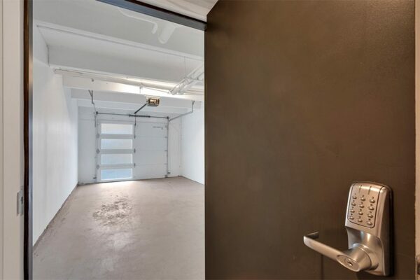 Garage with overhead door and door with keypad lock.