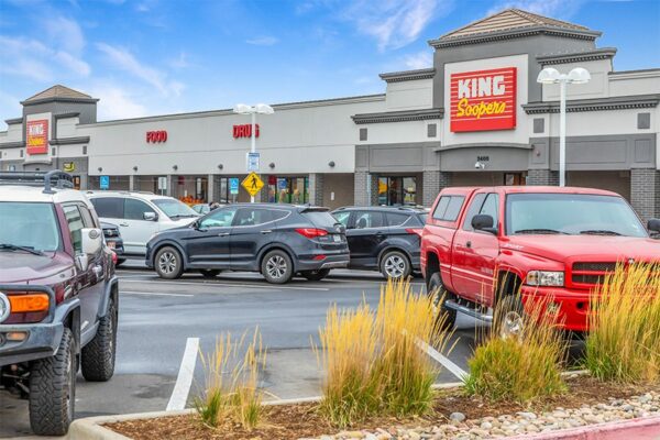 King Soopers storefront with large parking lot and grassy landscaping.