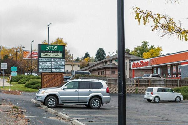 3705 Kipling Office Center with large parking lot and AutoZone store behind.