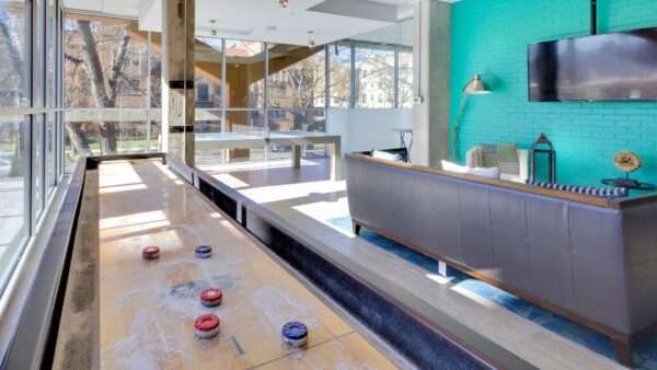 shuffle board, ping pong table, and tv in community room