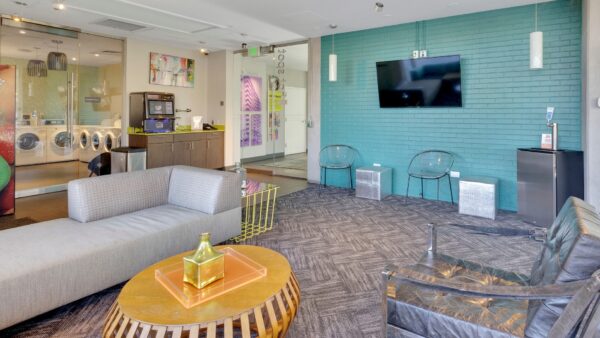 community room with laundry, couches, tv, and vending machine