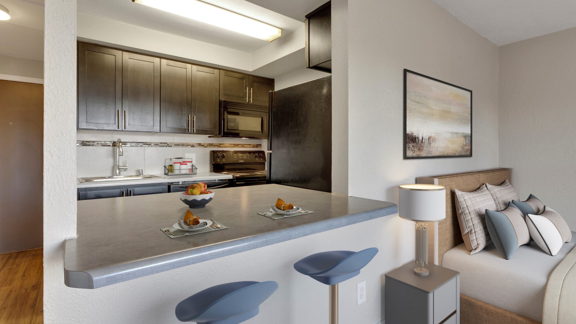 studio apartment with kitchen nook and ben in the living area