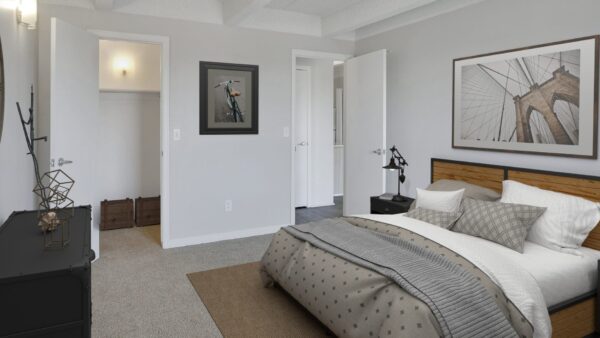 bedroom with large closet and entrance to kitchen