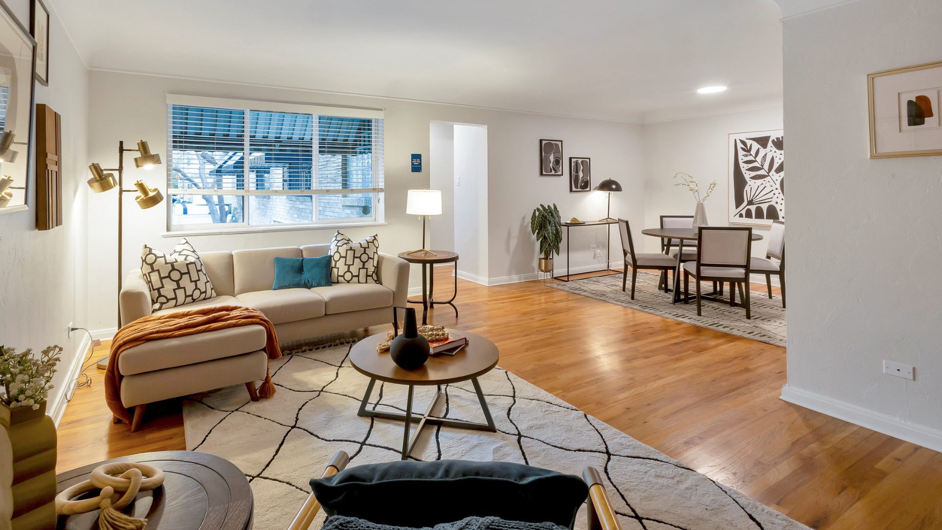 living room with couch, large window, and dining seating