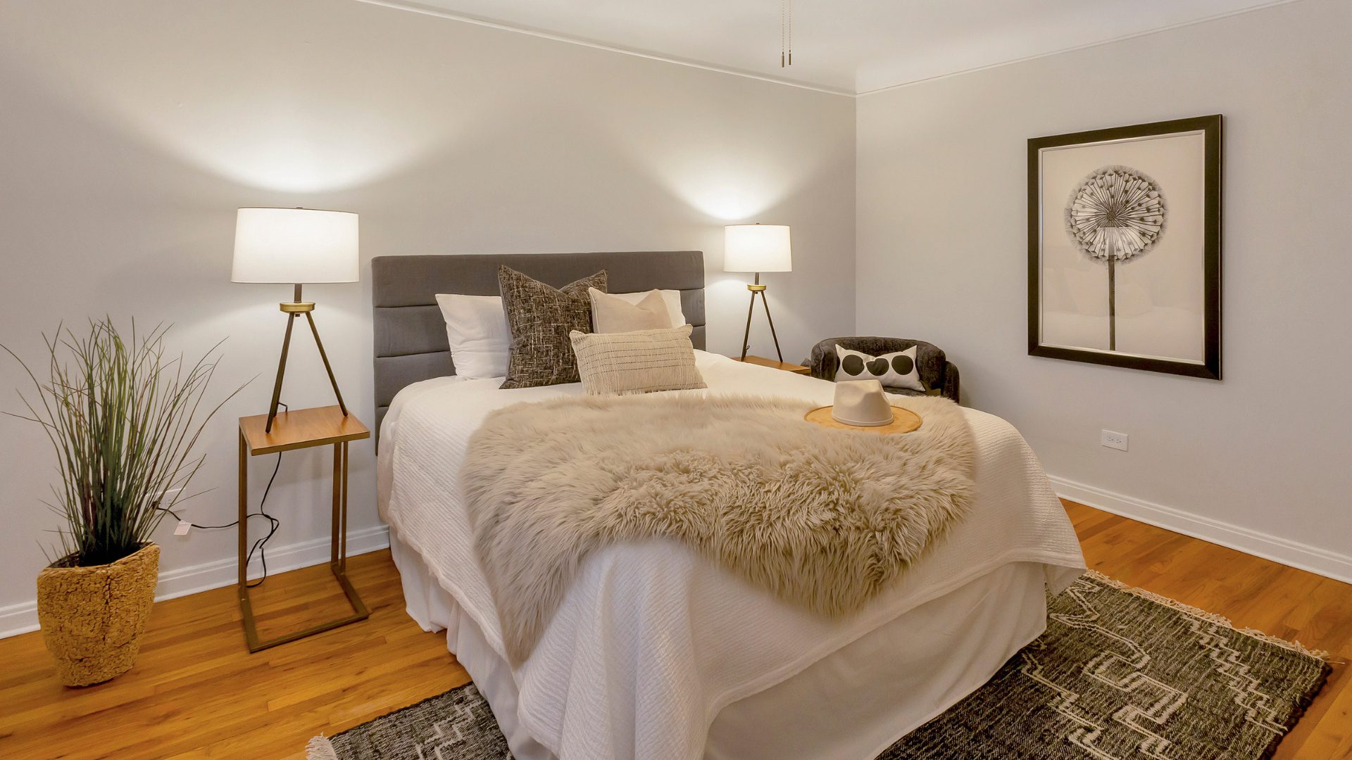 bedroom with large bed and night stands with lots of lighting