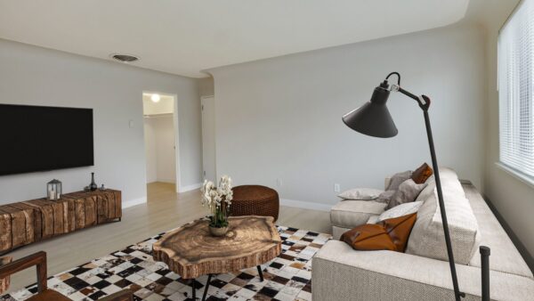 living room with coucha nd tv with coffee table in the middle